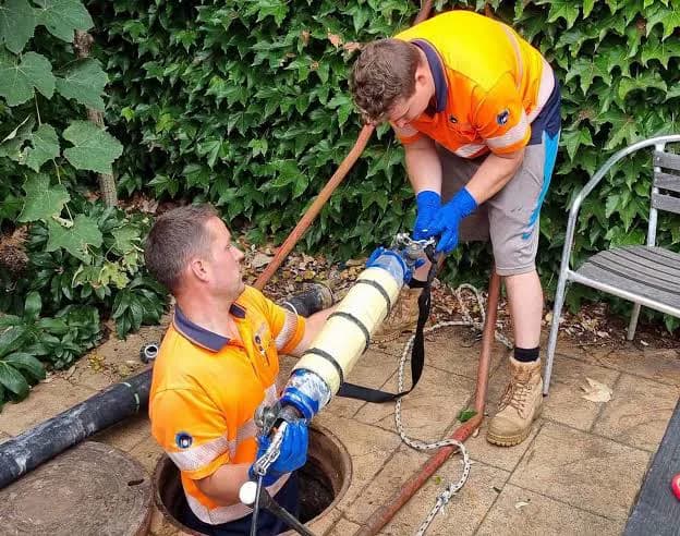 Patch lining equipment being prepared and inserted into a drain